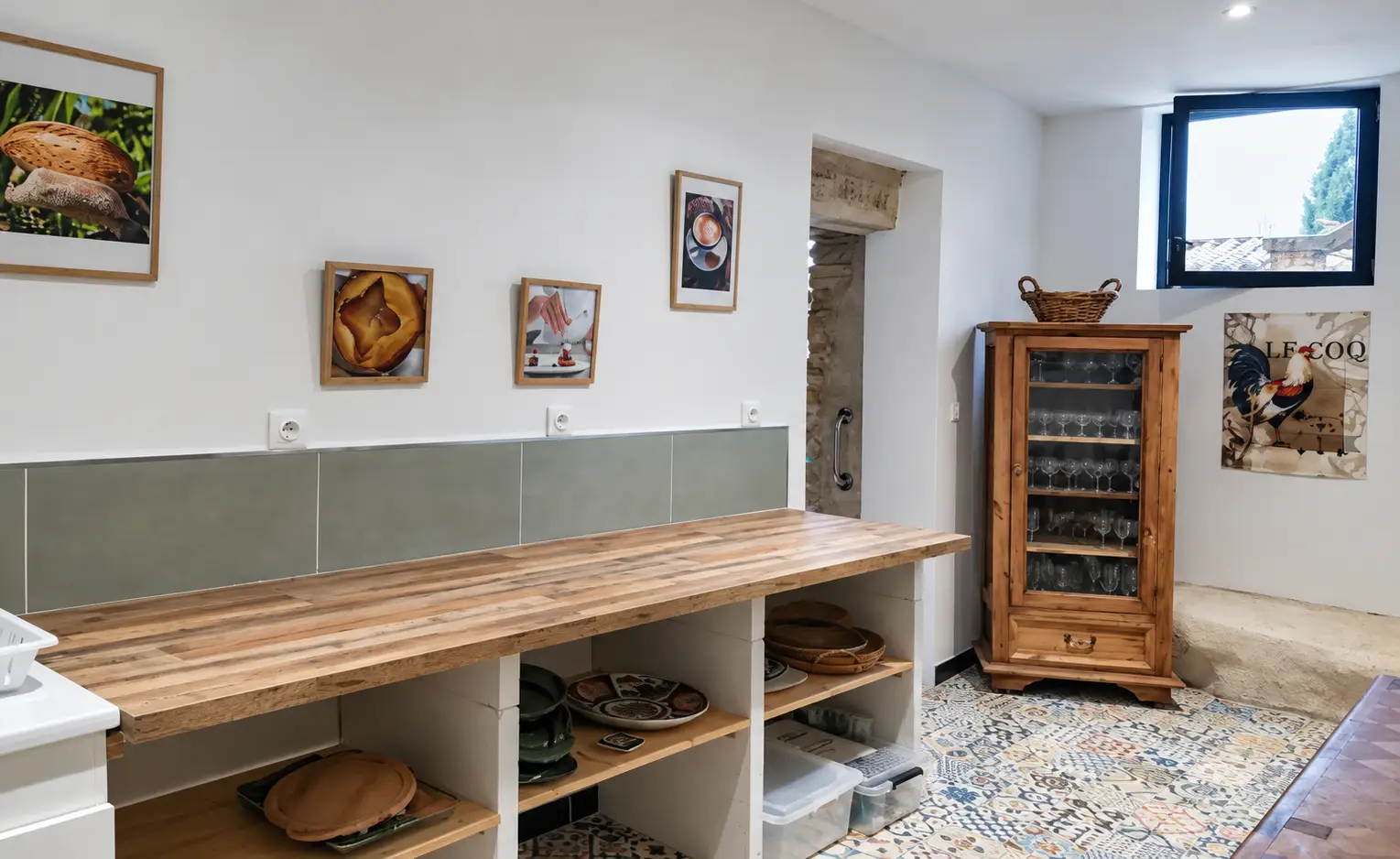 Holztheke, Geschirrregale und Glasvitrine in der Mas-Küche.